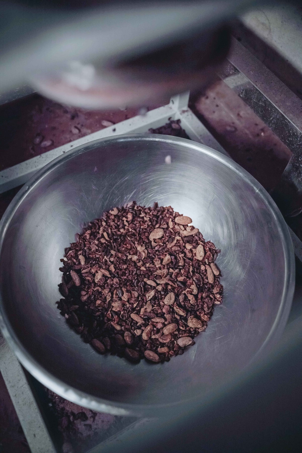 Cracking and winnowing cacao.