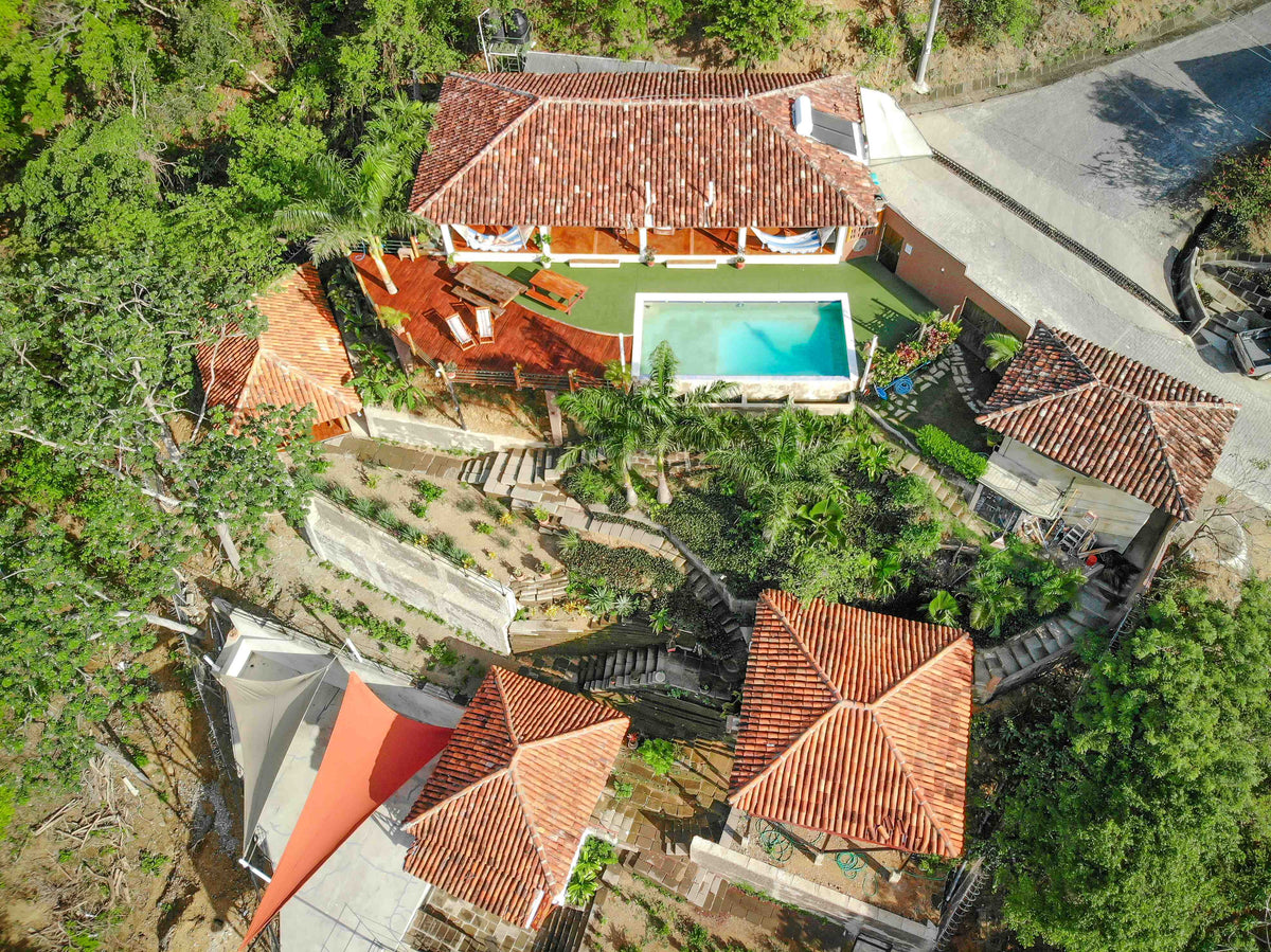 Casa Andalucia’s hillside pool and tiled-roof terraces surrounded by trees