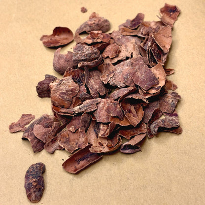 Cacao husk, the dried shell of the cacao bean, in a pile on kraft paper