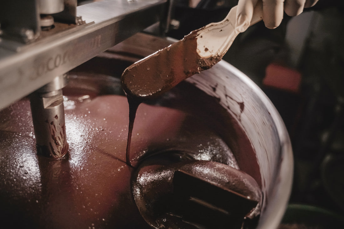 Stone-ground Nicaraguan chocolate ribboning off the spatula in the melangeur at Oro&