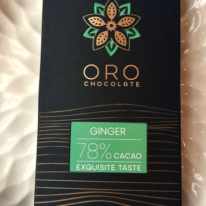 Close-up of the Oro Ginger 78% cacao chocolate bar label and the gold Oro flower mark on the black pack
