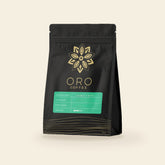 A 12oz bag of Oro single-origin Nicaraguan coffee, natural process, on a cream background