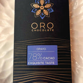 Close-up of the Oro Opayo 78% cacao chocolate bar label and the gold Oro flower mark on the black pack