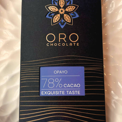 Close-up of the Oro Opayo 78% cacao chocolate bar label and the gold Oro flower mark on the black pack