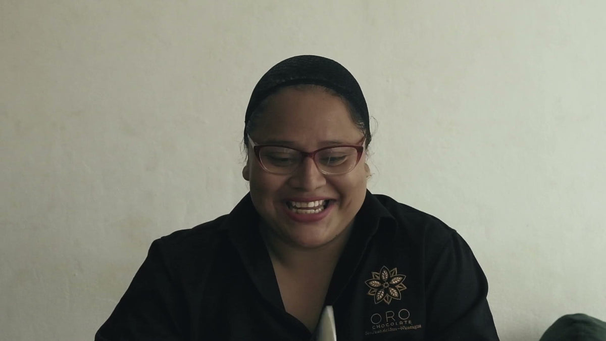 Karina, Oro's chocolate maker, smiling during her interview in an Oro shirt