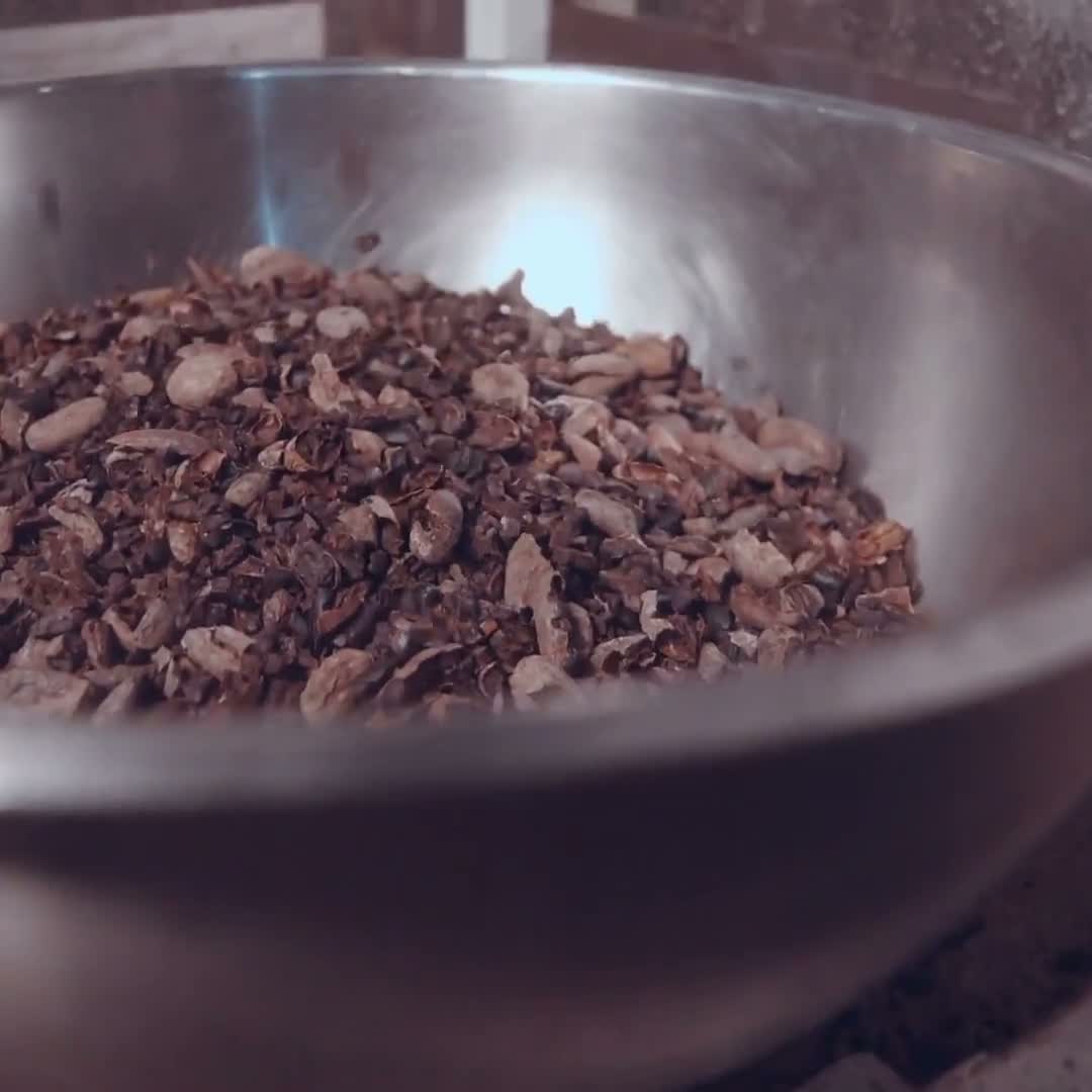 Cracked cacao nibs in a steel bowl.
