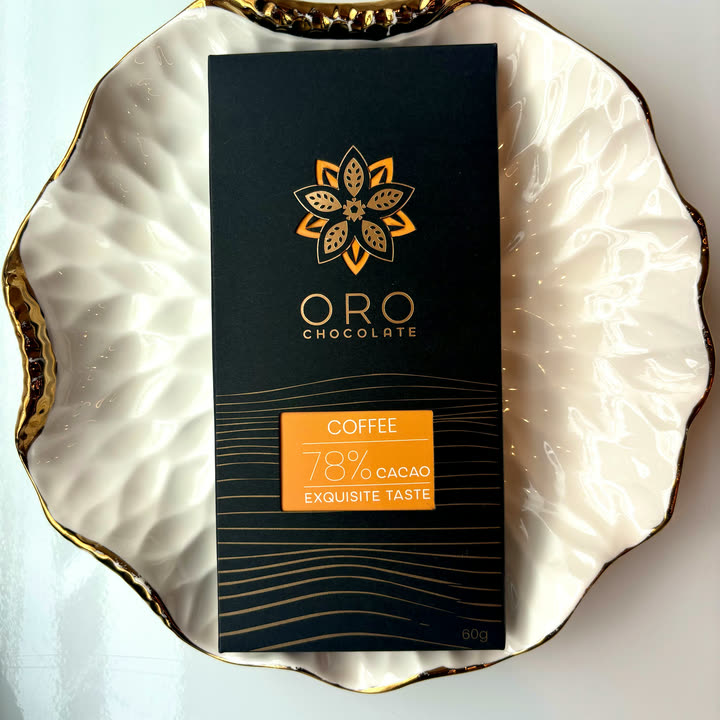An Oro Coffee 78% bar on a white plate with a gold rim