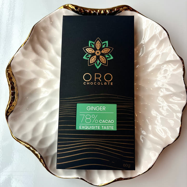 An Oro Ginger 78% bar on a white plate with a gold rim