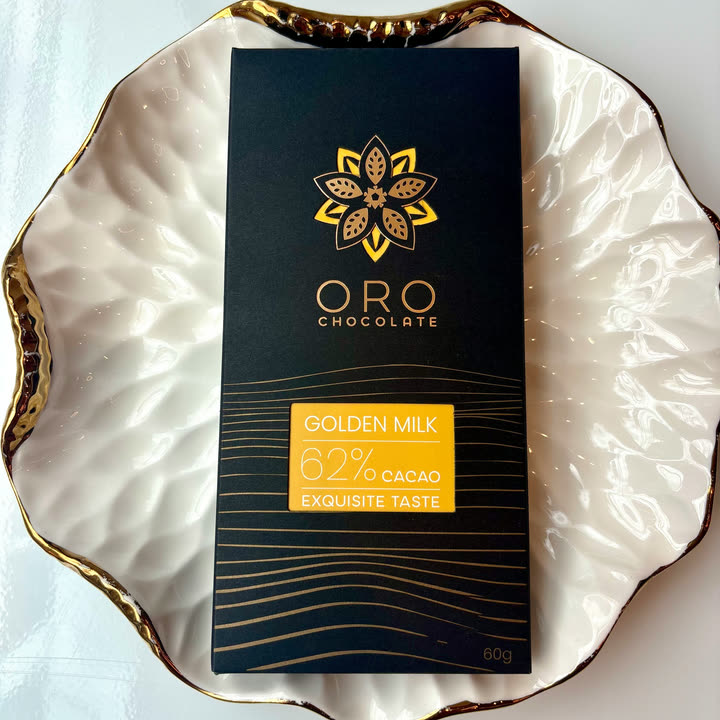 An Oro Golden Milk 62% bar on a white plate with a gold rim