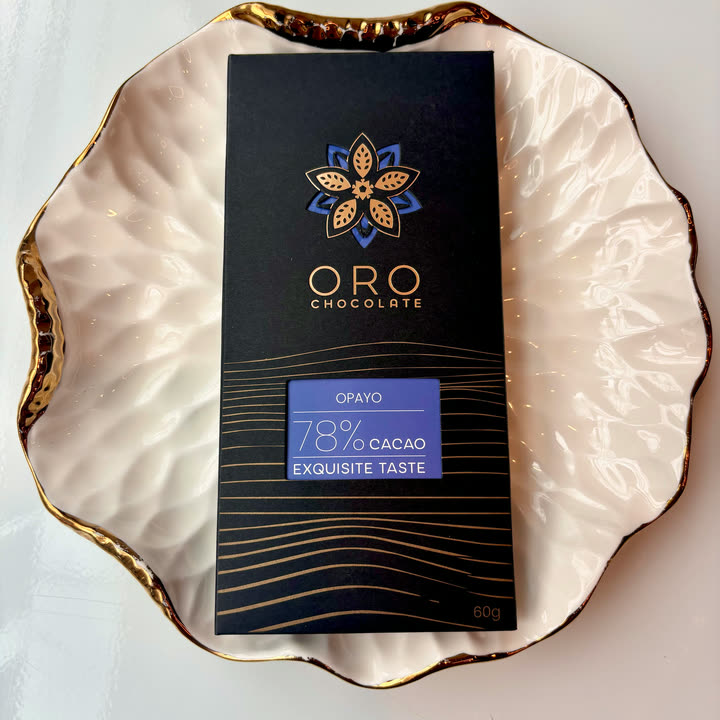 An Oro Opayo 78% bar on a white plate with a gold rim