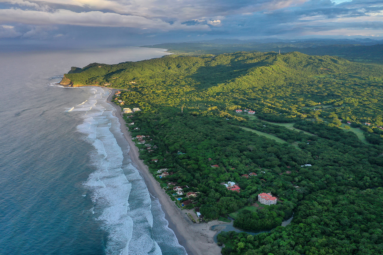 Waves rolling onto Nicaragua’s forested Pacific coastline