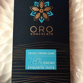 Close-up of the Oro Single Origin Dark 78% cacao chocolate bar label and the gold Oro flower mark on the black pack
