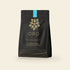 Oro Single Origin drinking chocolate, 12oz pouch, on a cream background